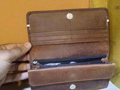 Side profile of women’s brown leather wallet